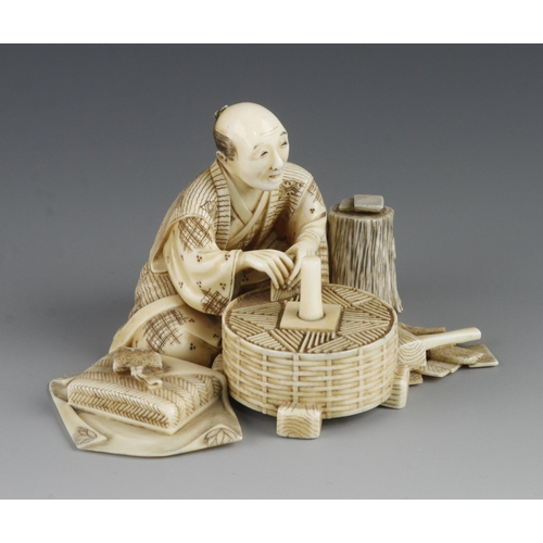 912 - An ivory okimono of a stonemason at his work with tool around 2