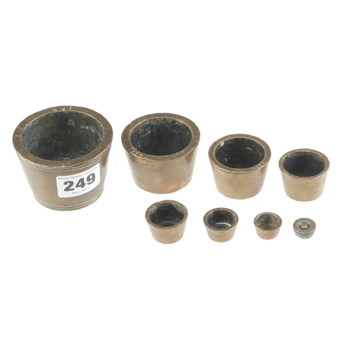 249 - An early set of 9 bronze 16oz Troy cup weights G