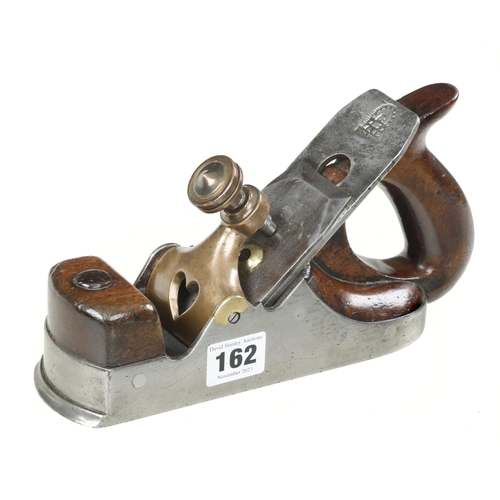 162 - A Scottish style iron smoother with over stuffed infill and handle with heart pierced brass lever, i... 