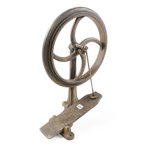 324 - An iron treadle wheel on fluted stand 16