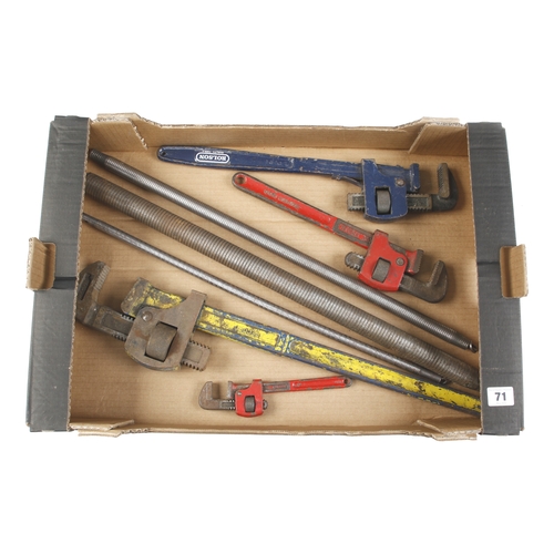 71 - Four stilson wrenches and 3 plumber's pipe bending springs G