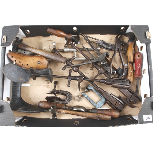 34 - A collection of 26 cobblers tools inc hammer, heal and seam irons, stretchers etc inc. a stitching c... 