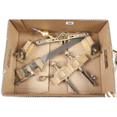 33 - Two small planes, pair of trammels, saws, bobs and other brass tools G