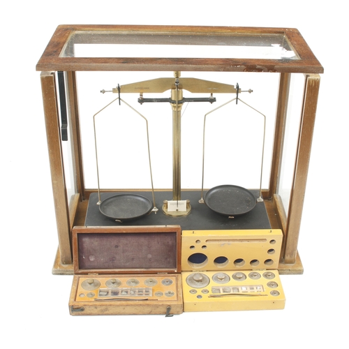 380 - Two complete sets of brass weights and a scientific balance in glass case (if required?) G+