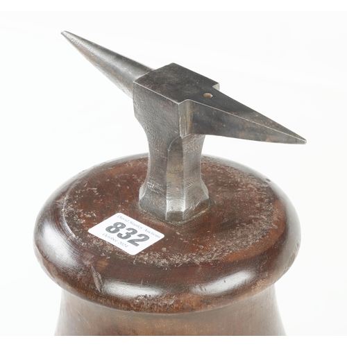 832 - A clockmaker's anvil set in mahogany stand 18