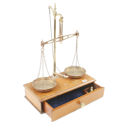 276 - A brass bullion scale by DAY & MILLWARD on mahogany base with drawer c/w set of Troy weights for 191... 