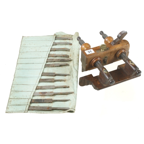 31 - A beech screwstem plough and 12 plough irons G+