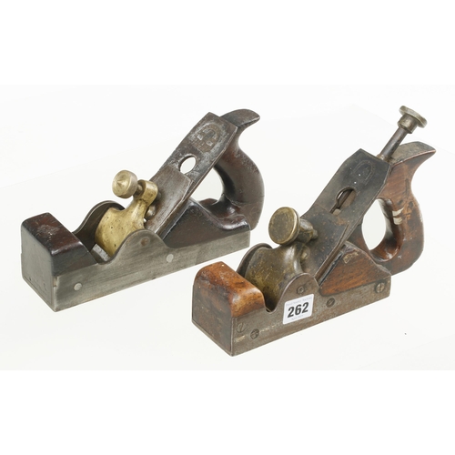 262 - Two parallel iron smoothers with cracked handles G