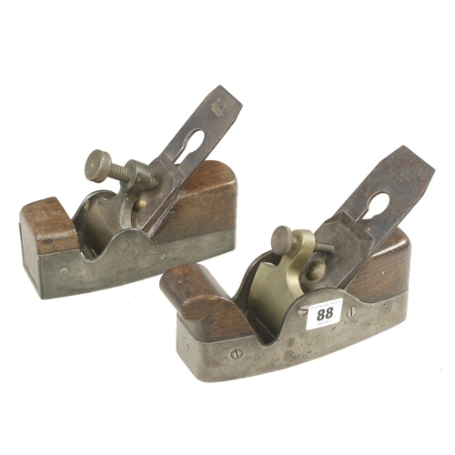 88 - Two iron smoothers with brass levers G+