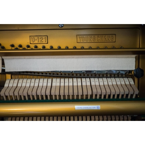 19 - Young Chang (c1987)  A Model U-121 upright piano in a bright ebonised case; together with a duet sto... 