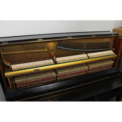 23 - Kawai (c1962)  An upright piano in a traditional style bright ebonised case