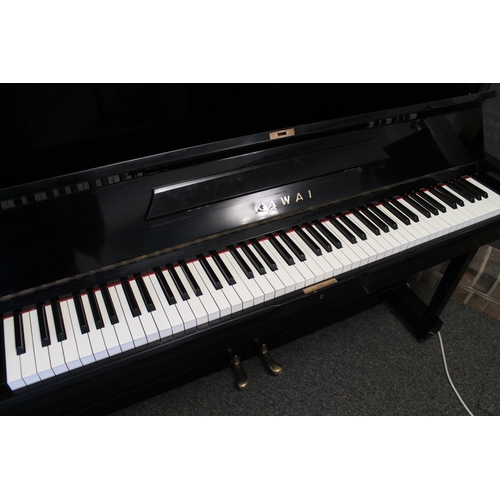 23 - Kawai (c1962)  An upright piano in a traditional style bright ebonised case