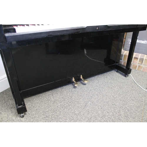 23 - Kawai (c1962)  An upright piano in a traditional style bright ebonised case