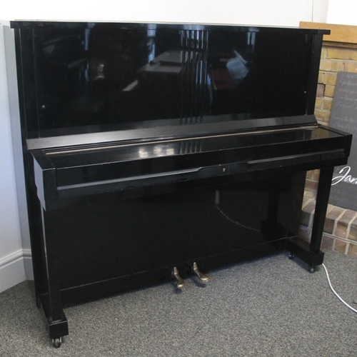 23 - Kawai (c1962)  An upright piano in a traditional style bright ebonised case