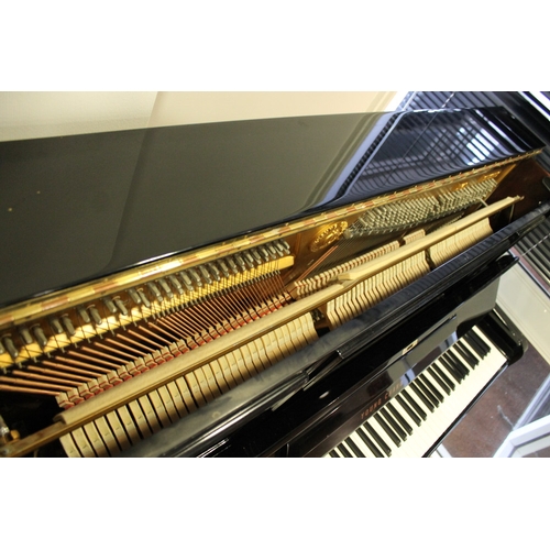 19 - Young Chang (c1987)  A Model U-121 upright piano in a bright ebonised case; together with a duet sto... 