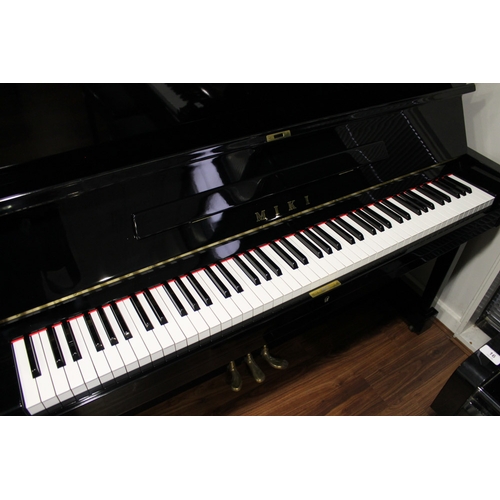 11 - Miki  A 121cm Model MU1D upright piano in a bright ebonised case.