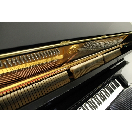 11 - Miki  A 121cm Model MU1D upright piano in a bright ebonised case.