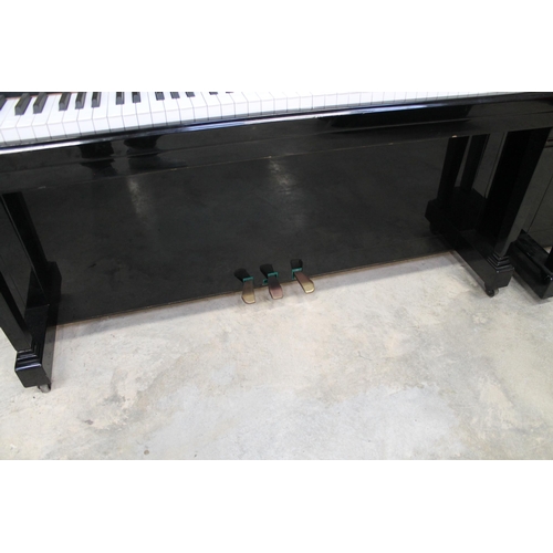 23 - ElysianA recent upright piano in a traditional ebonised case.