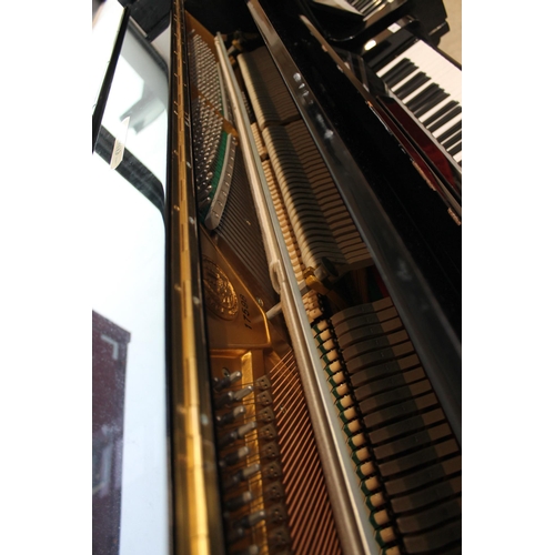 23 - ElysianA recent upright piano in a traditional ebonised case.