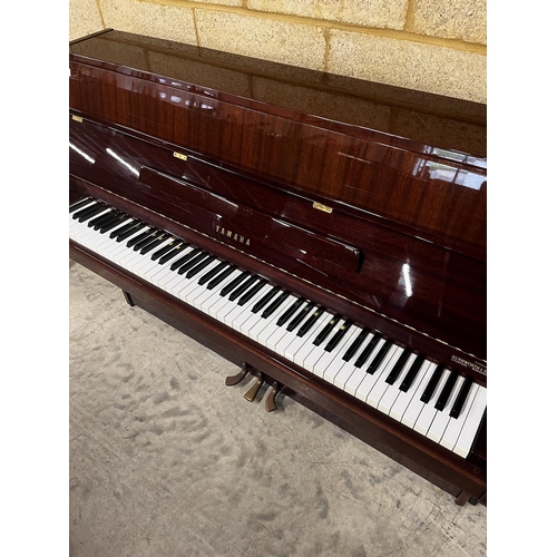 101 - Yamaha (c1980)A Model M5J upright piano in a bright mahogany case; together with a stool.