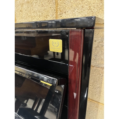 105 - Yamaha (c2000)A Model LX-113 T-PE upright piano in a bright ebonised case; together with a stool.... 