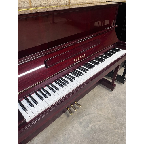 11 - Yamaha (c2006)A Model YU 121C upright piano in a bright mahogany case; together with a stool.