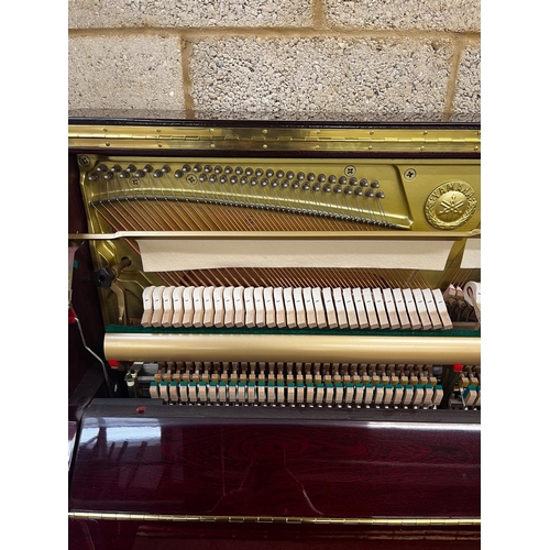 11 - Yamaha (c2006)A Model YU 121C upright piano in a bright mahogany case; together with a stool.