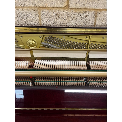 11 - Yamaha (c2006)A Model YU 121C upright piano in a bright mahogany case; together with a stool.