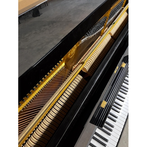 114 - Yamaha (c1985)A Model U1 upright piano in a bright ebonised case.