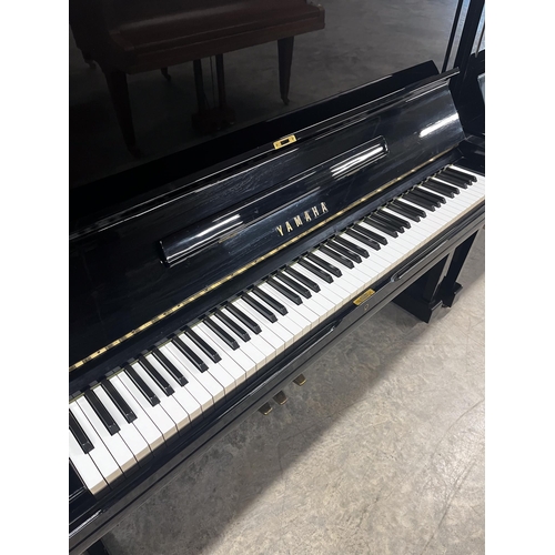 117 - Yamaha (c1974)A Model U3H upright piano in a bright ebonised case.