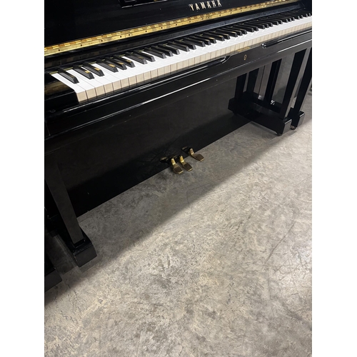 117 - Yamaha (c1974)A Model U3H upright piano in a bright ebonised case.