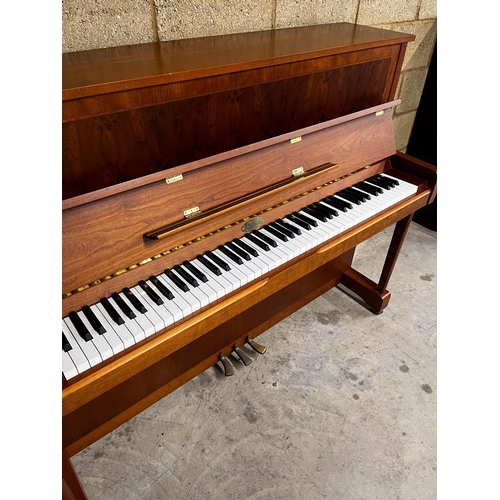 119 - Kemble (c1997)An upright piano in a traditional crossbanded yew and cherry wood case; together with ... 
