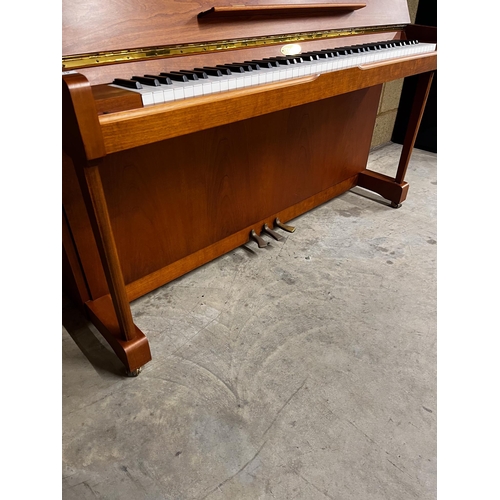 119 - Kemble (c1997)An upright piano in a traditional crossbanded yew and cherry wood case; together with ... 