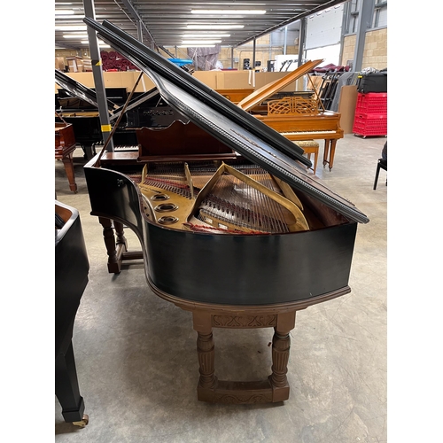 12 - Blüthner (c1886)A grand piano in a carved mahogany and blue painted case, raised on 3 sets of dual t... 