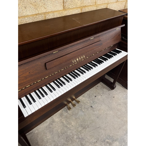 19 - Yamaha (c2000)A Model P110N upright piano in a modern style satin mahogany case; together with a sto... 