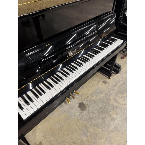 25 - Blüthner (c2015)A Model C upright piano in a traditional bright ebonised case; together with an adju... 