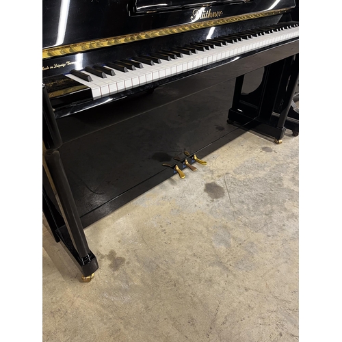 25 - Blüthner (c2015)A Model C upright piano in a traditional bright ebonised case; together with an adju... 