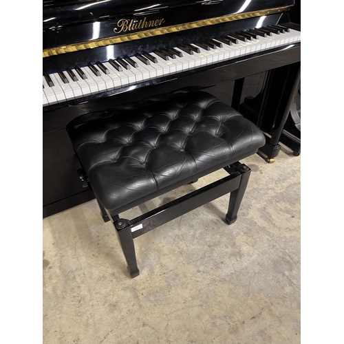 25 - Blüthner (c2015)A Model C upright piano in a traditional bright ebonised case; together with an adju... 
