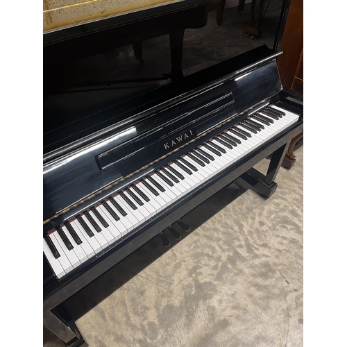 27 - Kawai (c1985)A Model KS-2F upright piano in a bright ebonised case; together with a stool.