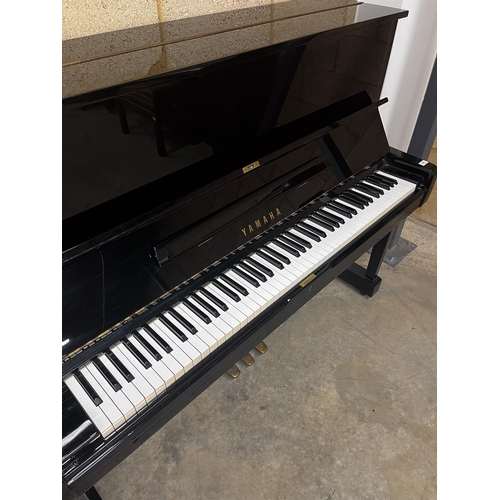 41 - Yamaha (c1973)A Model U1 upright piano in a traditional bright ebonised case.