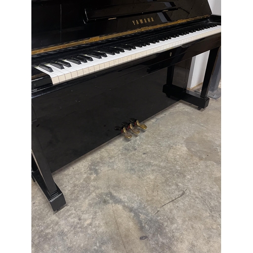 41 - Yamaha (c1973)A Model U1 upright piano in a traditional bright ebonised case.