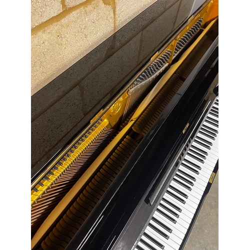 41 - Yamaha (c1973)A Model U1 upright piano in a traditional bright ebonised case.