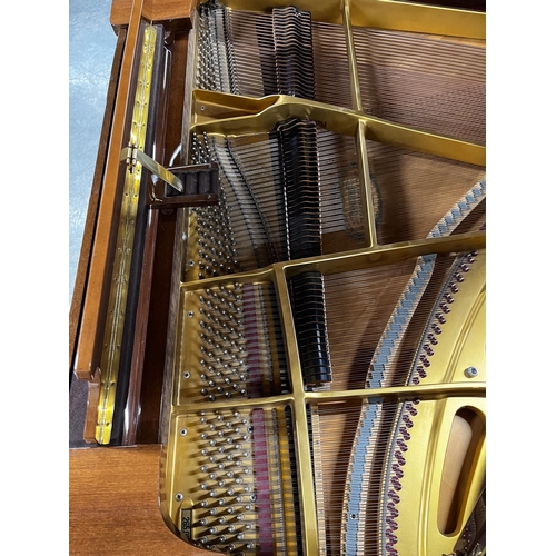 42 - Schimmel (c1988)A 5ft 8in Model 174T grand piano in bright walnut case on square tapered legs.