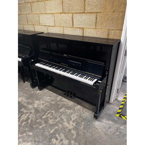 51 - Yamaha (c1975)A Model U1 upright piano in a bright ebonised case.