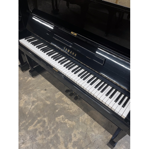 51 - Yamaha (c1975)A Model U1 upright piano in a bright ebonised case.