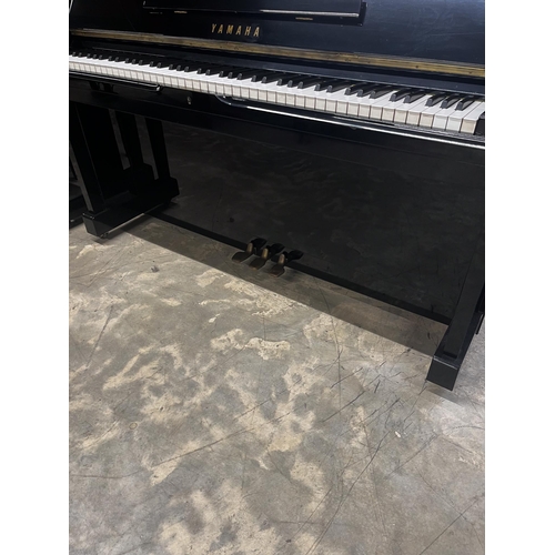 51 - Yamaha (c1975)A Model U1 upright piano in a bright ebonised case.