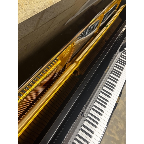51 - Yamaha (c1975)A Model U1 upright piano in a bright ebonised case.