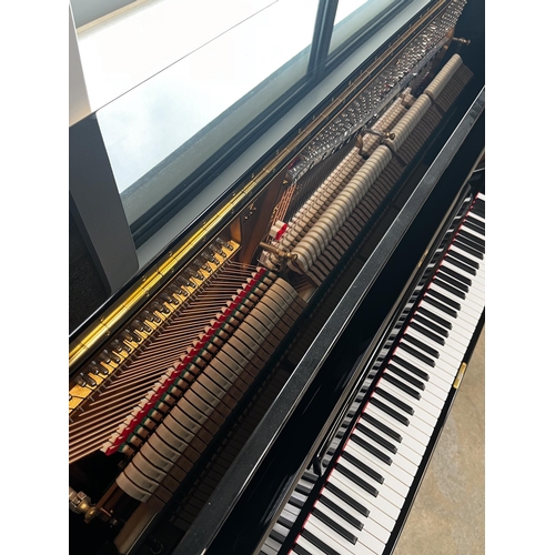 55 - Steinway (c2014)A Model K upright piano in a bright ebonised case.