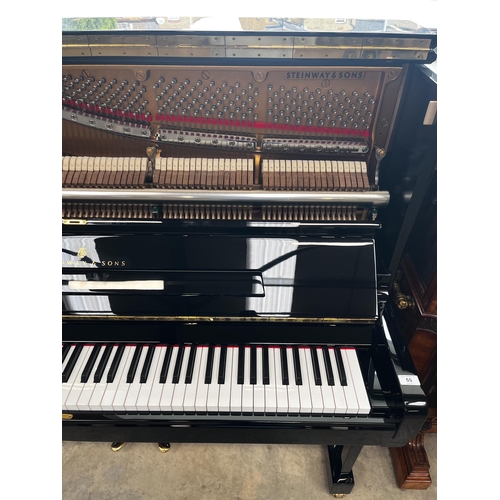 55 - Steinway (c2014)A Model K upright piano in a bright ebonised case.