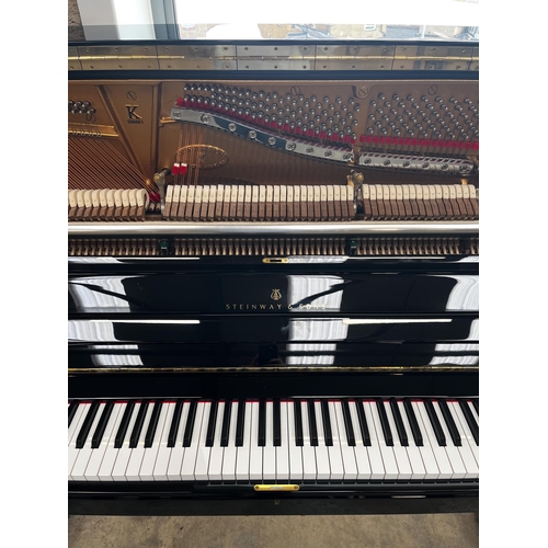 55 - Steinway (c2014)A Model K upright piano in a bright ebonised case.